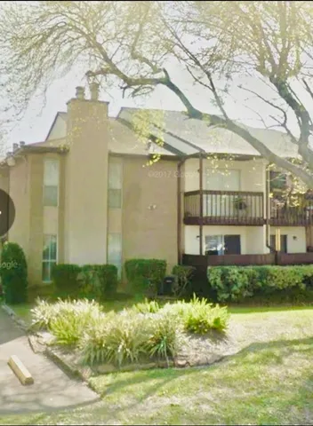 a front view of a house with a yard and lake view