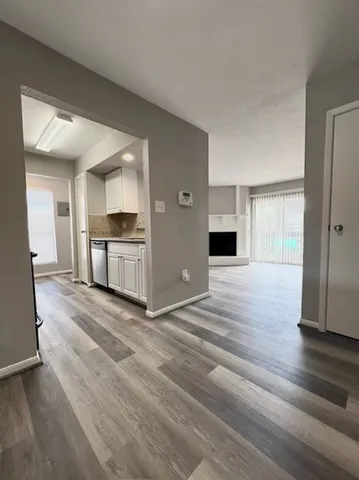 a view of a kitchen with a stove cabinets and wooden floor