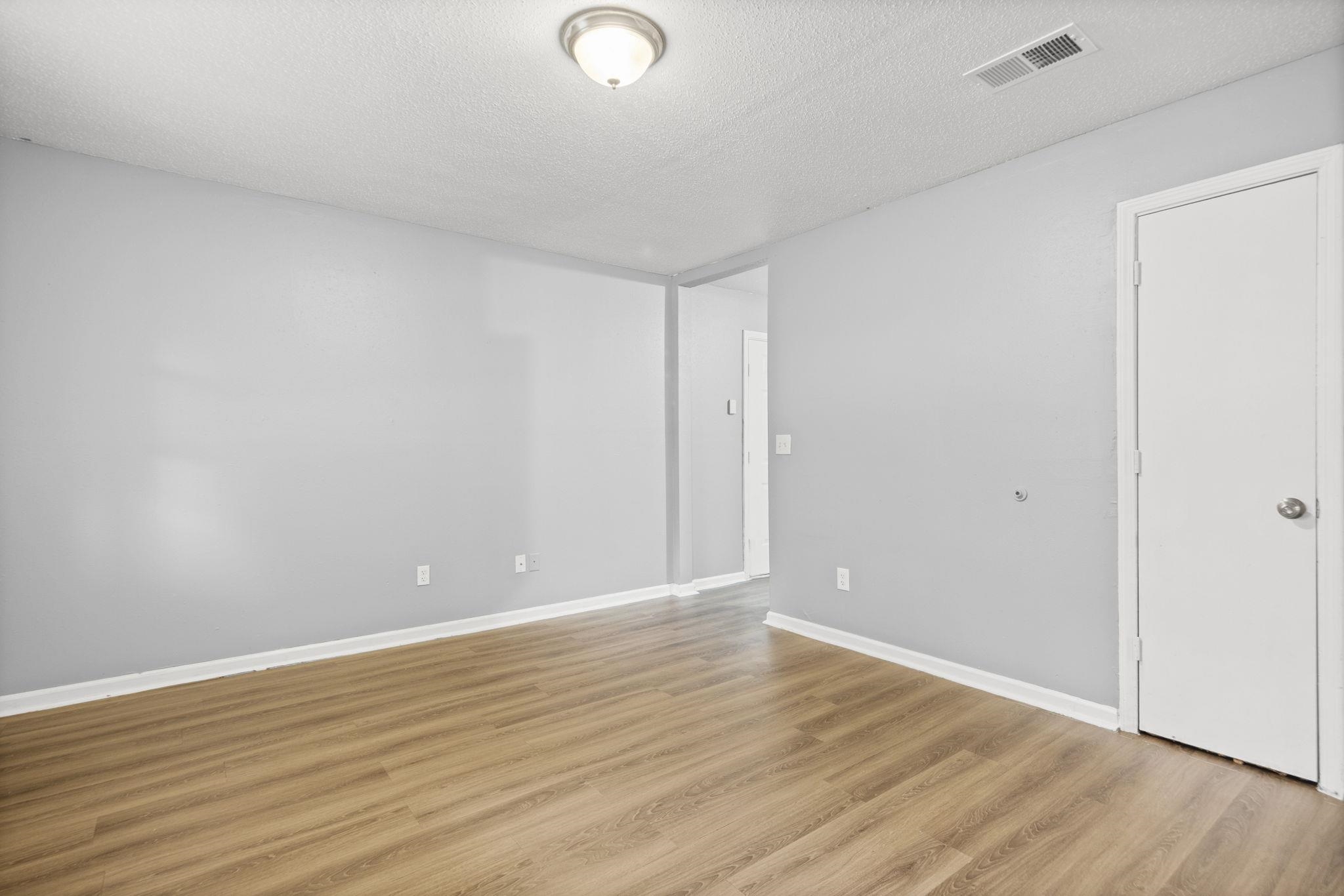 3480 Tallyho Road Memphis, TN 38128 - Photo 11 of 20 a view of an empty room with wooden floor