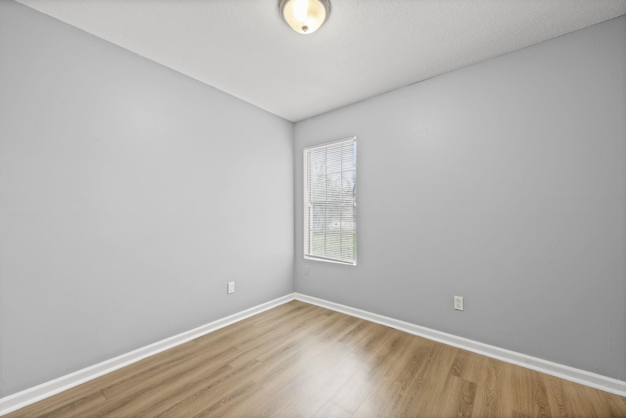 3480 Tallyho Road Memphis, TN 38128 - Photo 15 of 20 a view of an empty room with wooden floor and windows