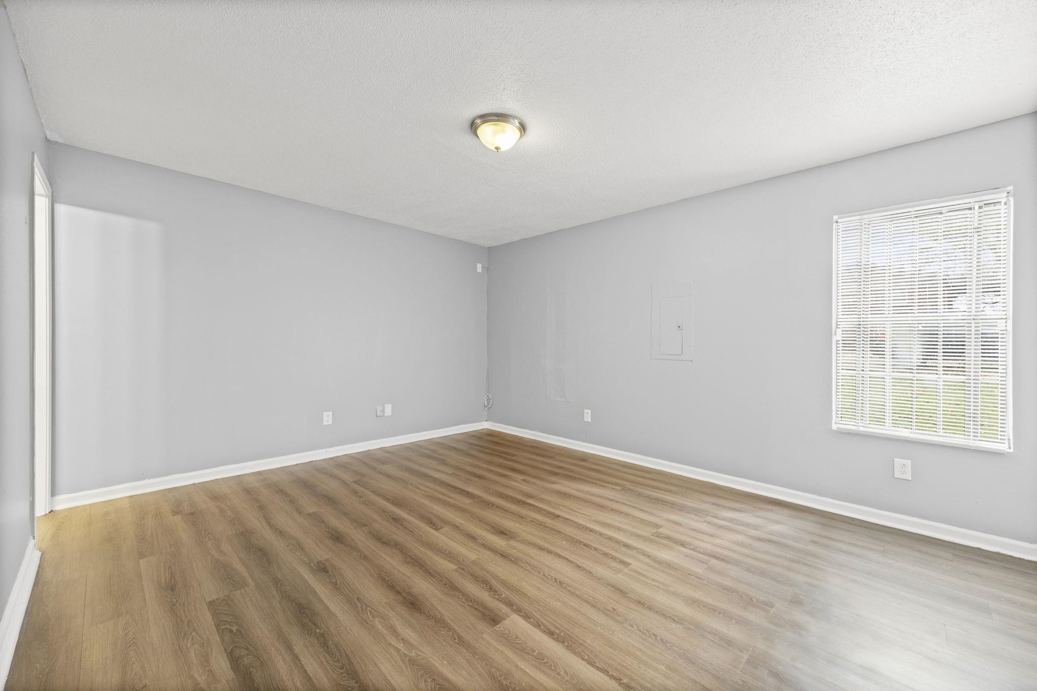 3480 Tallyho Road Memphis, TN 38128 - Photo 18 of 20 a view of an empty room with wooden floor and a window