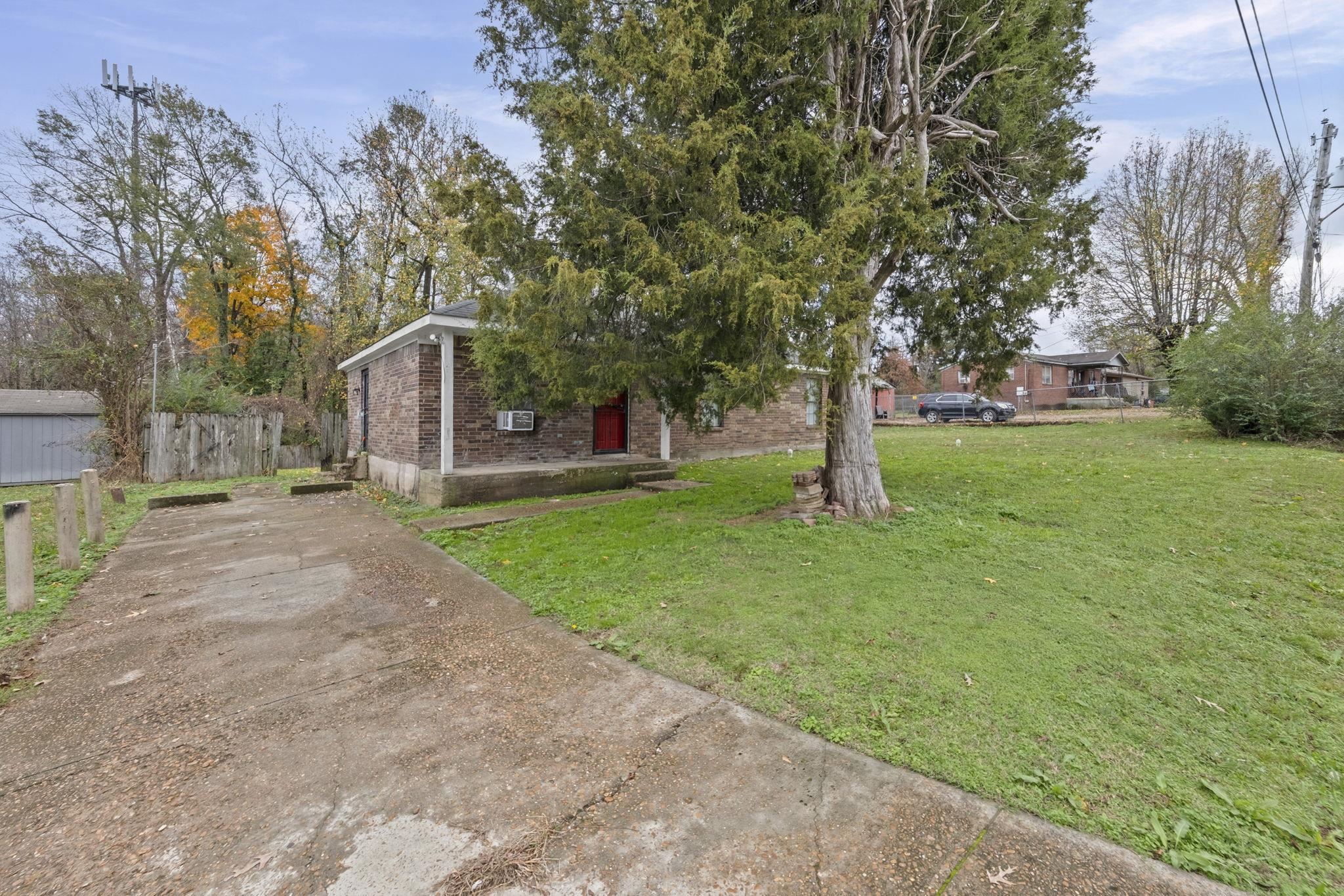 3480 Tallyho Road Memphis, TN 38128 - Photo 2 of 20 a view of a house with a yard and tree s