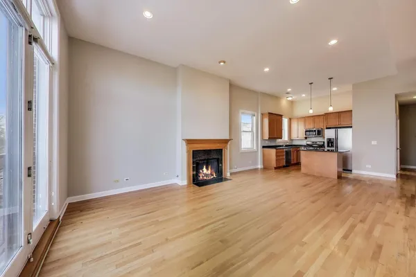a view of kitchen with refrigerator and fireplace