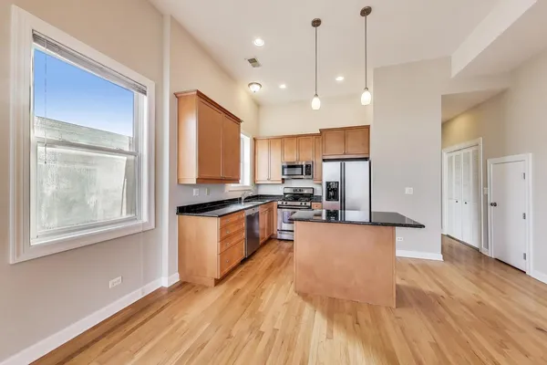 a large kitchen with lots of counter space a sink and appliances