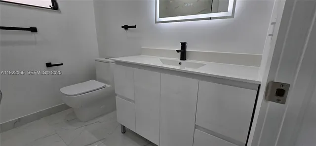 a bathroom with a toilet and a sink