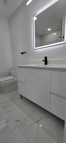 a bathroom with a toilet and a sink