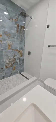 a bathroom with a glass shower door