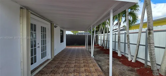 a view of an empty room with a fireplace and a window