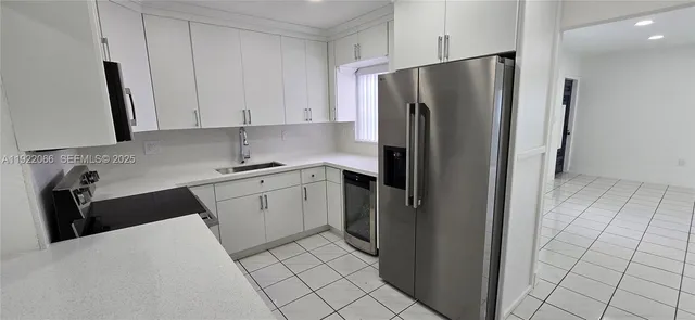 a kitchen with a refrigerator and a sink