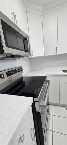a kitchen with a stove and a microwave