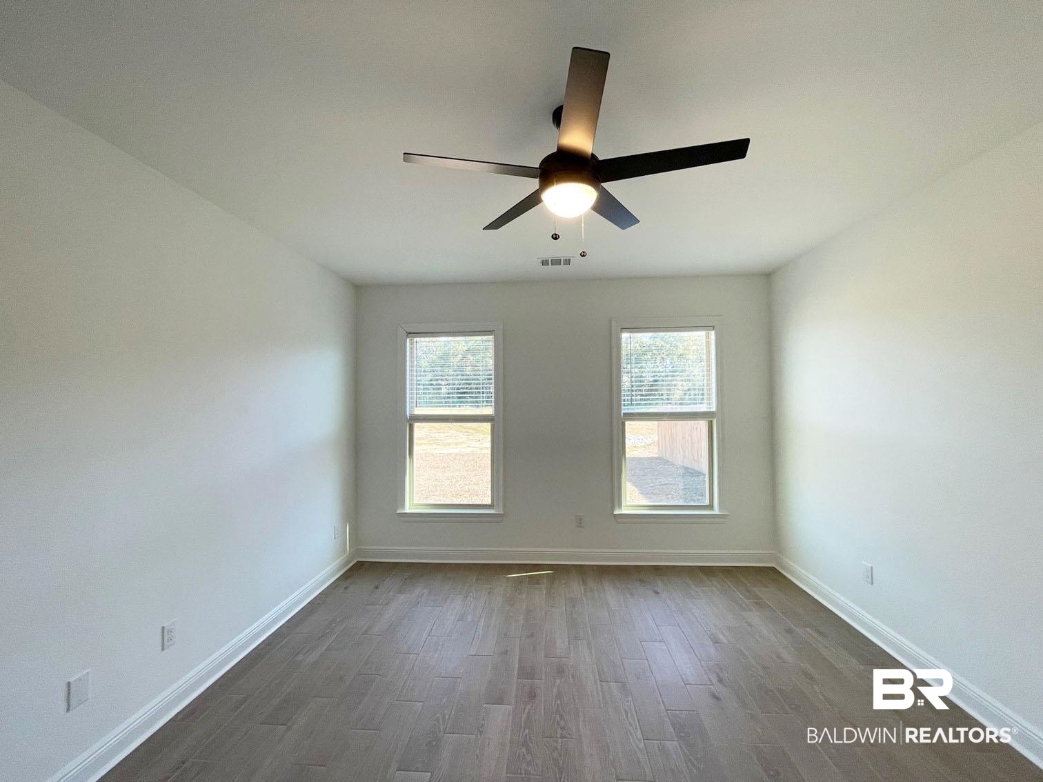 1396 Fenton Circle Foley, AL 36535 - Photo 5 of 14 Empty room with dark wood-type flooring and ceiling fan