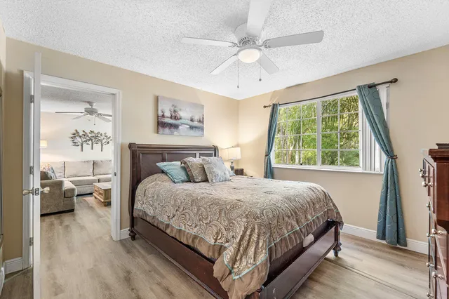 a bedroom with a large bed and a chandelier