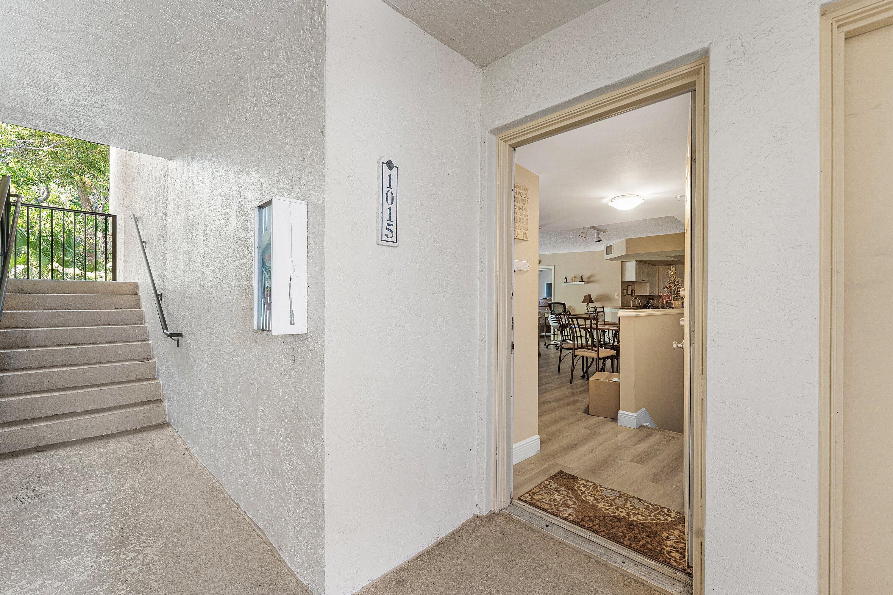 1000 Crestwood Court South, Unit 1015 Royal Palm Beach, FL 33411 - Photo 14 of 21 a view of a hallway with wooden floor and a living room