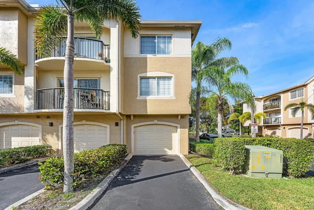 a front view of a house with a garden and plants