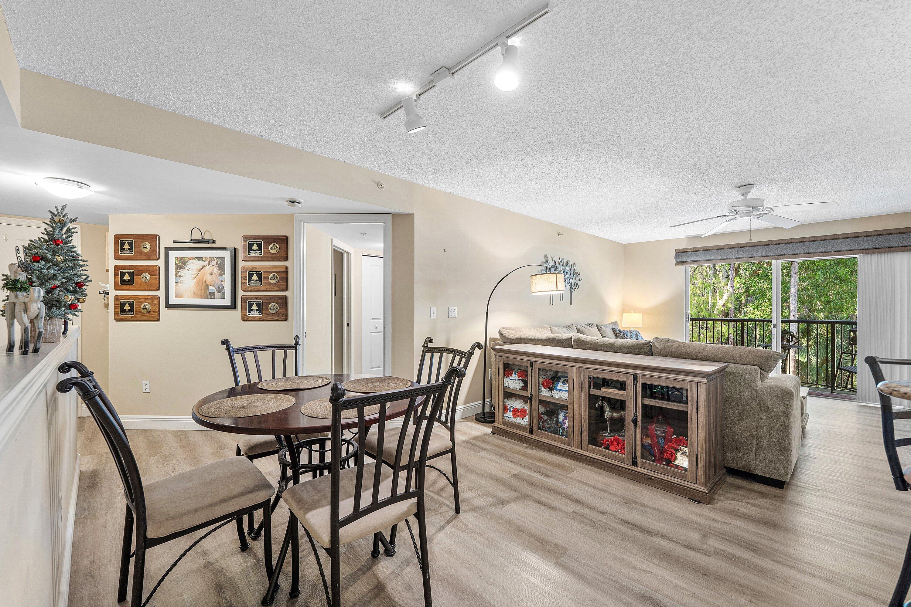 1000 Crestwood Court South, Unit 1015 Royal Palm Beach, FL 33411 - Photo 5 of 21 a view of a dining room with furniture window and wooden floor