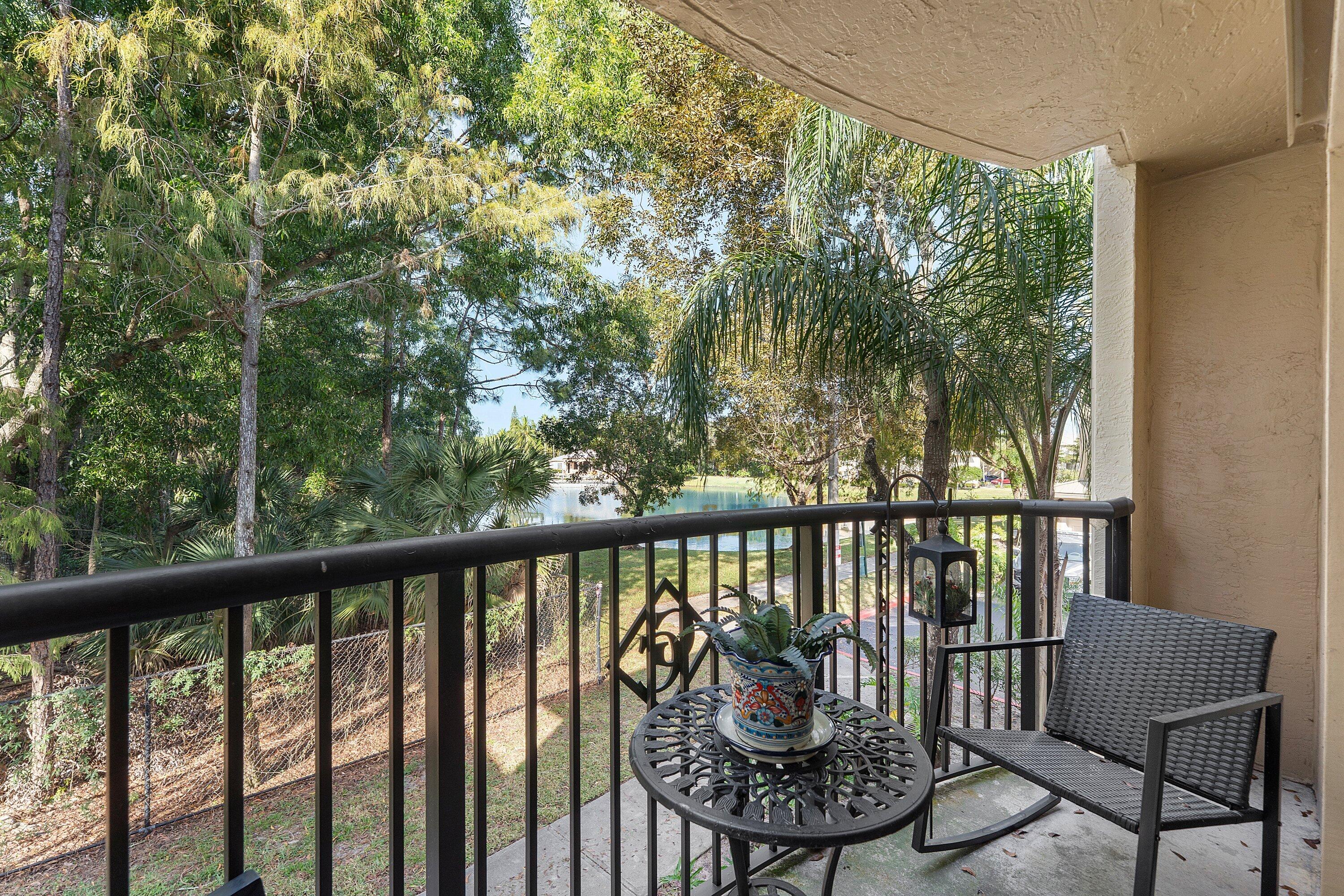 1000 Crestwood Court South, Unit 1015 Royal Palm Beach, FL 33411 - Photo 7 of 21 a view of a balcony with chairs