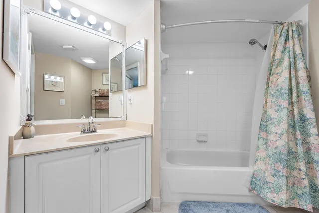 a bathroom with a bathtub a sink a vanity and a shower