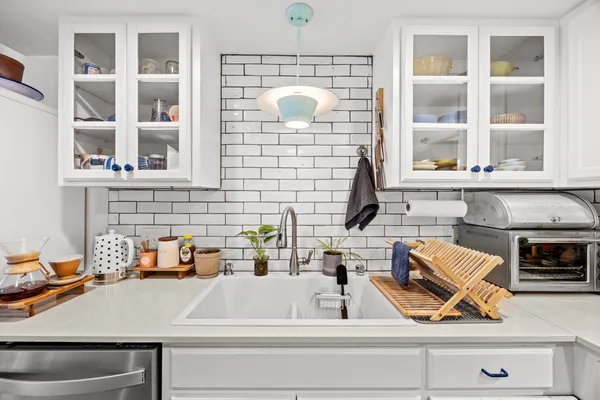 a kitchen with a sink and a stove next to a window