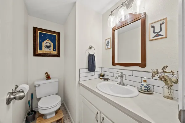 a bathroom with a toilet a sink and mirror