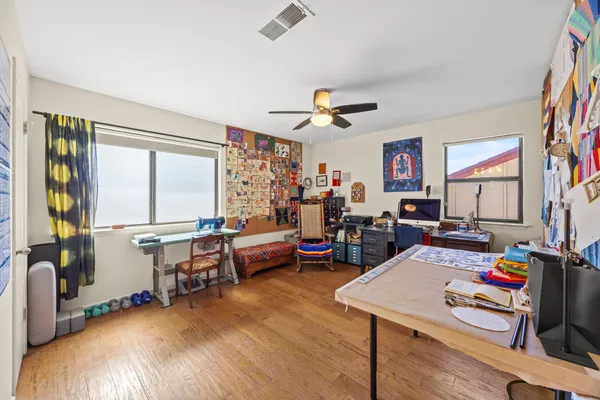 a view of a workspace with furniture and a window