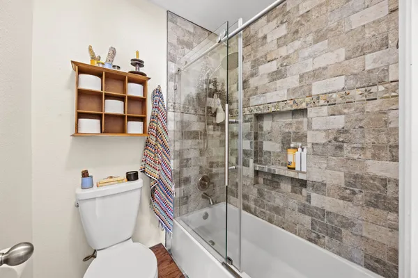 a bathroom with a bathtub and a toilet