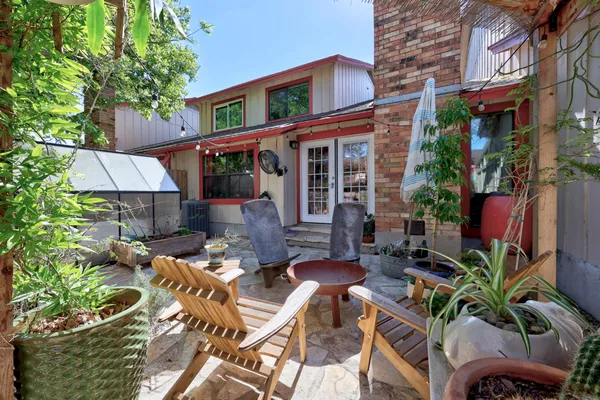 a view of backyard with outdoor seating a patio and plants