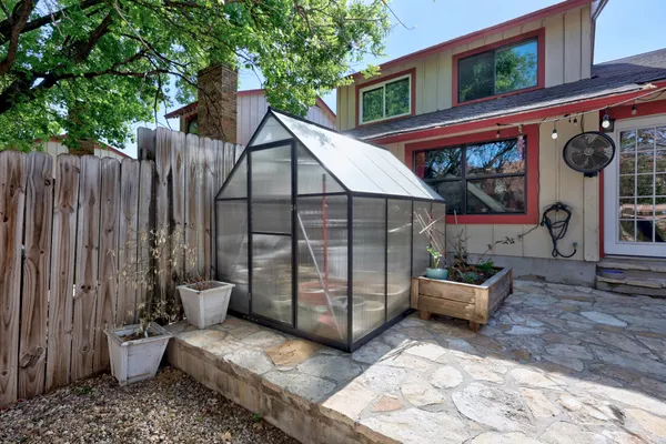 a view of a patio with wooden wall and roof