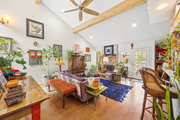 a living room with furniture and wooden floor