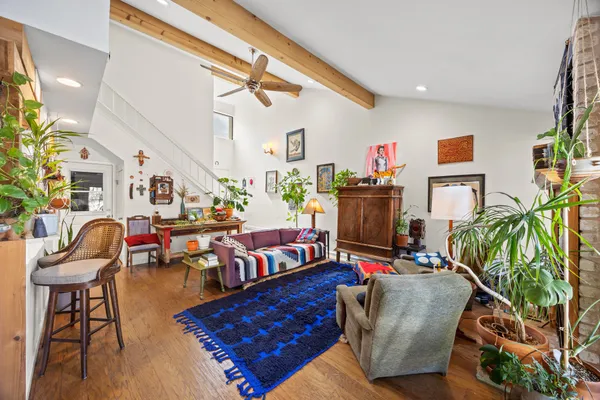 a living room with furniture and wooden floor