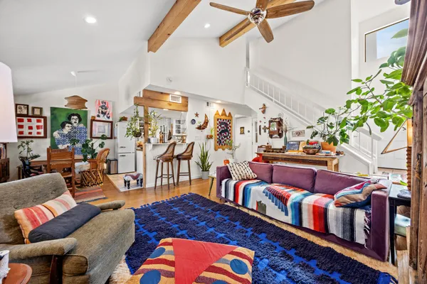 a living room with lots of furniture and a rug