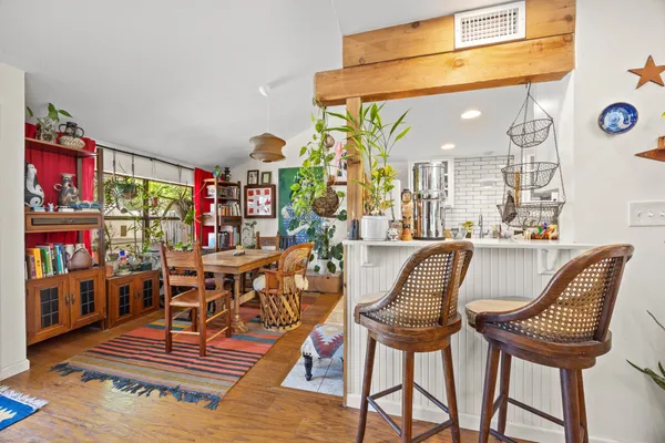 a dining room with furniture and wooden floor
