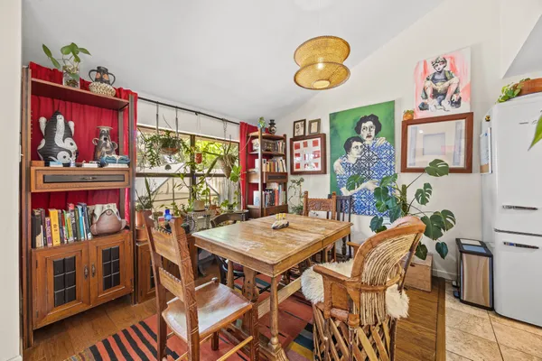 a view of a dining room with furniture and chandelier