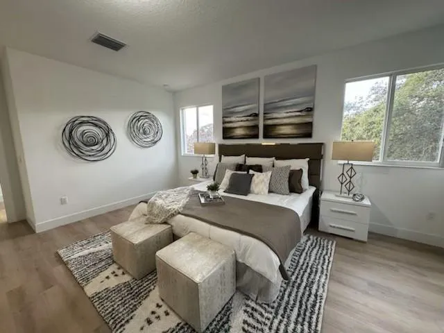 a bedroom with a bed and a window