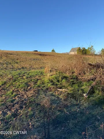 a view of a large building with mountains in the background