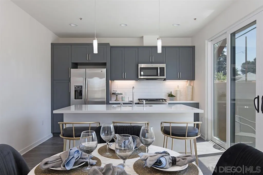 4015 Mission Inn Avenue Riverside, CA 92501 - Photo 11 of 25 a kitchen with stainless steel appliances a dining table and chairs