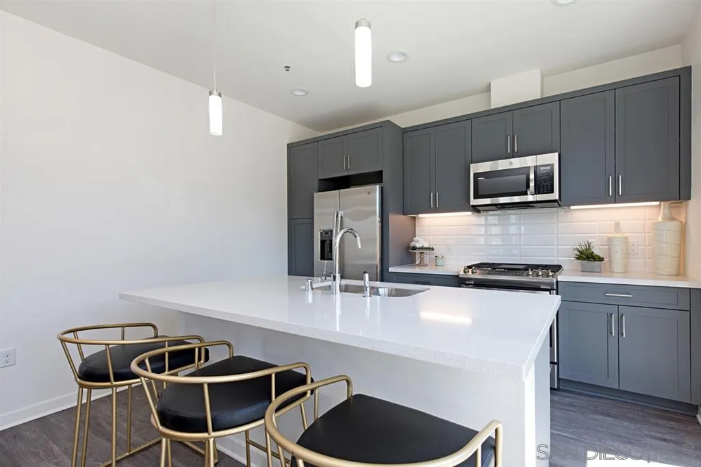 4015 Mission Inn Avenue Riverside, CA 92501 - Photo 9 of 25 a kitchen with stainless steel appliances granite countertop a stove a sink and a microwave