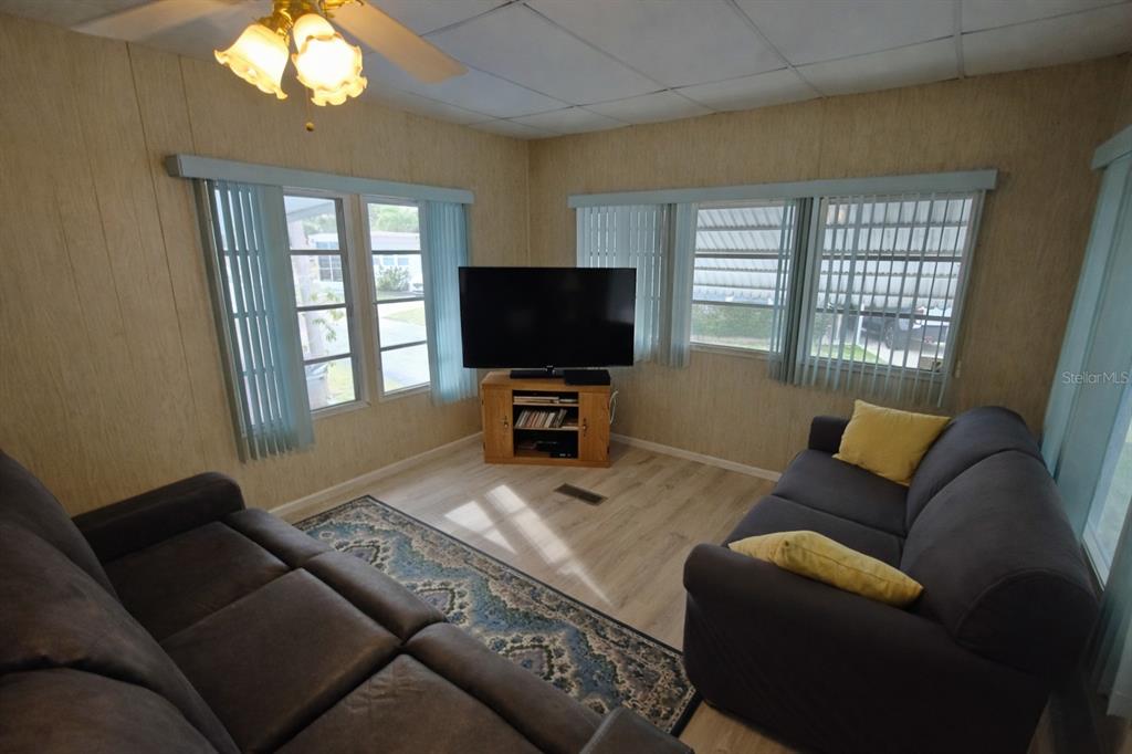 1600 Old Coachman Rd., Unit 806 Clearwater, FL 33765 - Photo 13 of 15 a living room with furniture and a flat screen tv