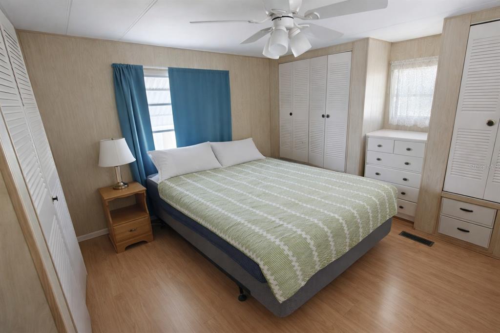 1600 Old Coachman Rd., Unit 806 Clearwater, FL 33765 - Photo 2 of 15 a bedroom with a bed and a chandelier