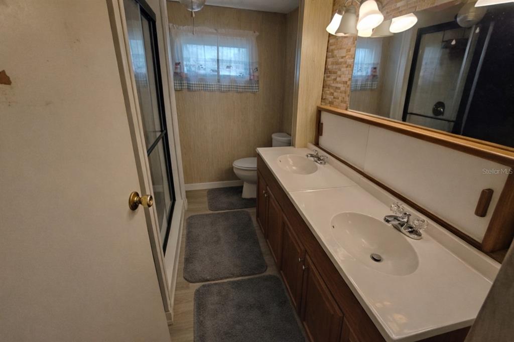 1600 Old Coachman Rd., Unit 806 Clearwater, FL 33765 - Photo 3 of 15 a bathroom with a sink a toilet and shower