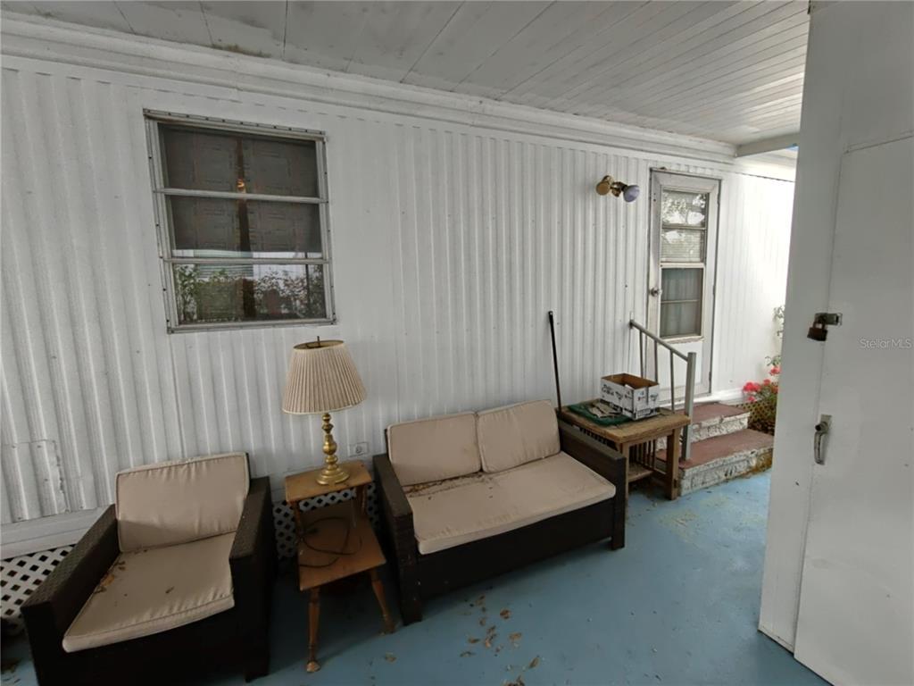 1600 Old Coachman Rd., Unit 806 Clearwater, FL 33765 - Photo 7 of 15 a living room with furniture and a window