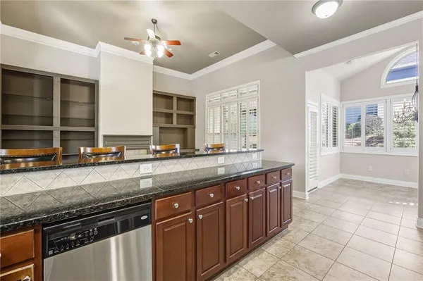 a kitchen with stainless steel appliances granite countertop a sink and a stove