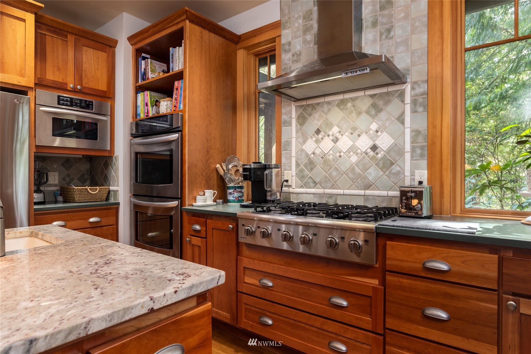 2133 Academy Road Bellingham, WA 98226 - Photo 6 of 40 a kitchen with stainless steel appliances granite countertop a stove and a refrigerator