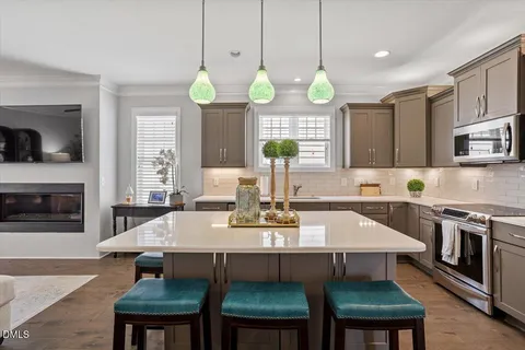 a large kitchen with a table and chairs