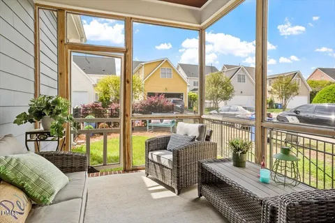 a living room with furniture and a floor to ceiling window
