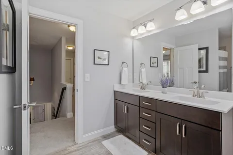 a bathroom with a double vanity sink and mirror