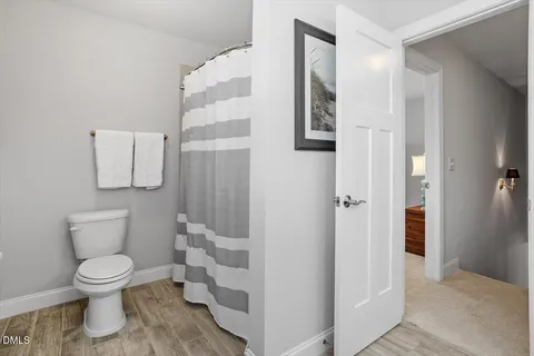 a white toilet sitting next to a bathroom sink
