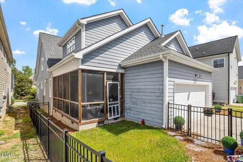 a view of a house with backyard and porch