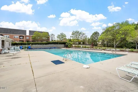 a view of a swimming pool and a yard