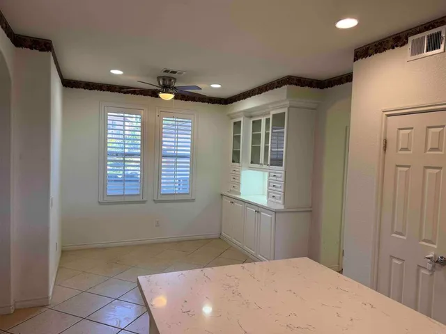 a spacious bathroom with a double vanity sink a mirror and a shower