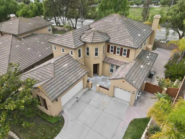 an aerial view of a house with a yard